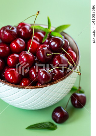 Natural organic cherries with copy space on pastel green background Natural organic cherries with copy space on pastel green background 141088666