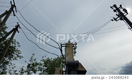 Rural electrical transformer substation and power distribution lines supplying energy to countryside community. essential public utilities. 141089243
