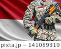Indonesia flag with soldier holding assault rifle 141089319