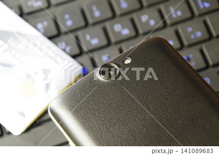 The smartphone with a camera on the background of your computer The smartphone with a camera on the background of your computer 141089683