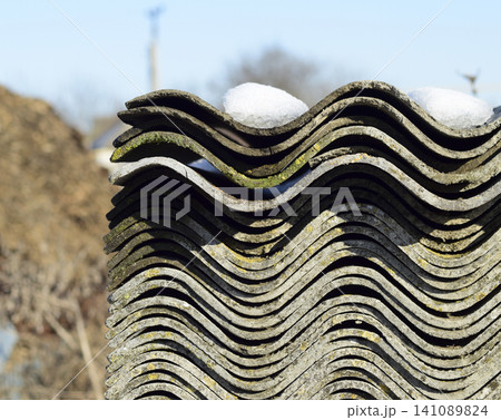 Folded neatly in a pile of old slate. Background of slate. Old building debris 141089824
