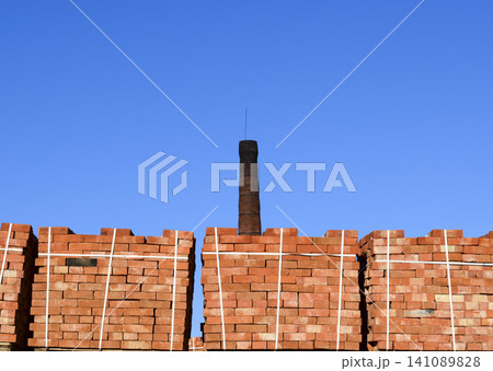 Red bricks stacked into cubes. Warehouse bricks. Storage brickworks products Red bricks stacked into cubes. Warehouse bricks. Storage brickworks products 141089828