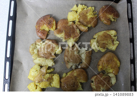 roasted smashed potatoes on a baking sheet top view roasted smashed potatoes on a baking sheet top view 141089883