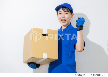 荷物を運ぶ笑顔の女性ドライバー 荷物を運ぶ笑顔の女性ドライバー 141090129