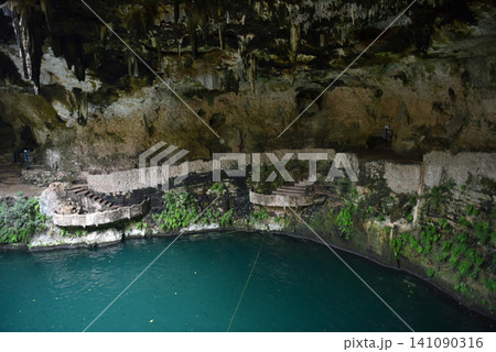 Underground cenote cave with turquoise water and stalactites Underground cenote cave with turquoise water and stalactites 141090316