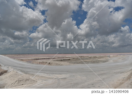 Expansive salt flat landscape under stormy clouds Expansive salt flat landscape under stormy clouds 141090406