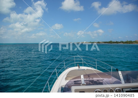 Yacht bow sailing toward tropical island shore Yacht bow sailing toward tropical island shore 141090485