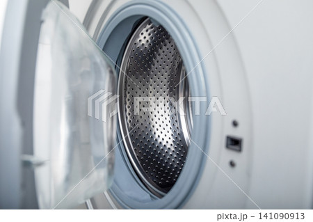 Close-up of washing machine drum ready for laundry. Efficient cleaning concept 141090913