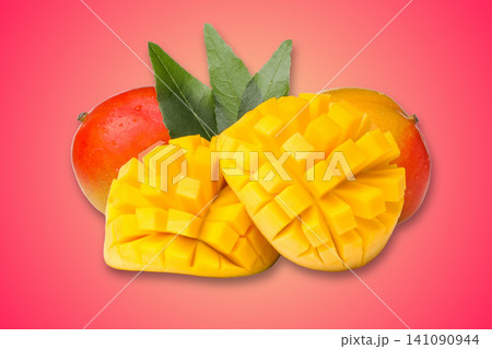 Freshly cut mango pieces showcase juicy yellow flesh beside whole mangoes 141090944