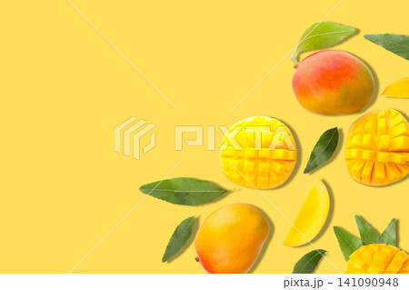 Mango slices and ripe fruits arranged pleasingly on vibrant backdrop Mango slices and ripe fruits arranged pleasingly on vibrant backdrop 141090948
