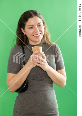 Young woman enjoys hot coffee Young woman enjoys hot coffee 141091643