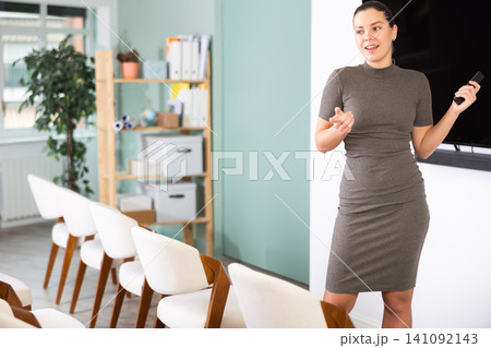 young woman in business clothes gives a presentation 141092143