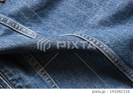 seam of blue denim texture background, jean fashion style seam of blue denim texture background, jean fashion style 141092158