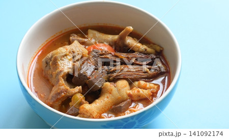 rice vermicelli with northern thai curry sauce on blue background rice vermicelli with northern thai curry sauce on blue background 141092174
