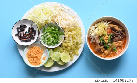 rice vermicelli with northern thai curry sauce on blue background rice vermicelli with northern thai curry sauce on blue background 141092175