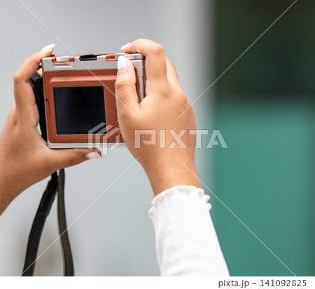 woman hands holding a compact digital camera is taking a photo with copy space. 141092825