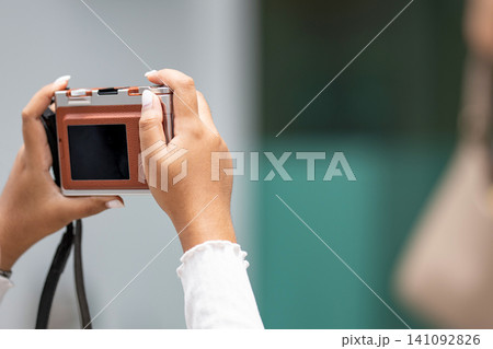 woman hands holding a compact digital camera is taking a photo with copy space. 141092826