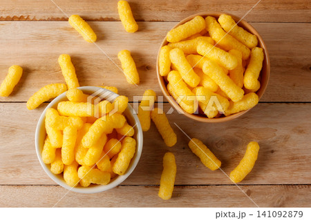 Crispy corn sticks served in two bowls on a rustic wooden table in a top view Crispy corn sticks served in two bowls on a rustic wooden table in a top view 141092879