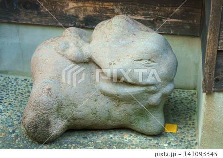 Kanazawa, Japan - Oct 6 2024, close-up view of a stone sculpture of a smiling frog lying on its side in Higashi Chaya District, at daytime, Kanazawa, Japan Kanazawa, Japan - Oct 6 2024, close-up view of a stone sculpture of a smiling frog lying on its side in Higashi Chaya District, at daytime, Kanazawa, Japan 141093345