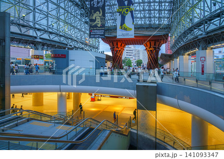 Kanazawa, Japan - Oct 6 2024, panoramic view of the east entrance of Kanazawa Station, with Tsuzumi-mon Gate in the background, in evening, with people walking on a background, Kanazawa, Japan  141093347