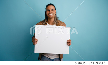 Latino man holding blank sign for advertising Latino man holding blank sign for advertising 141093413