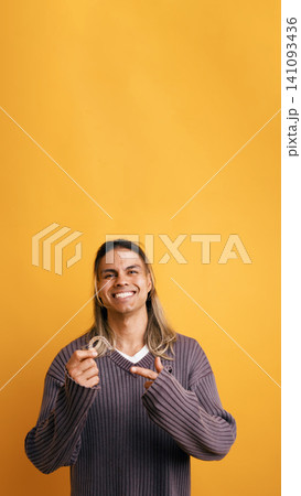 Young latino man holding invisible dental aligner Young latino man holding invisible dental aligner 141093436