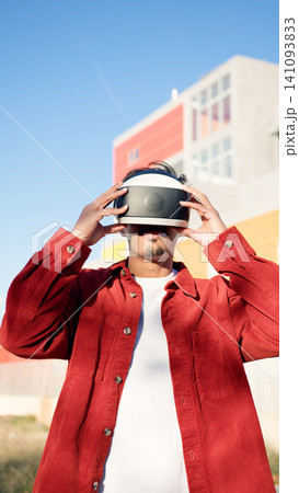 Moroccan man experiencing virtual reality in metaverse Moroccan man experiencing virtual reality in metaverse 141093833