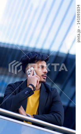 Moroccan man making business call on smartphone Moroccan man making business call on smartphone 141093834