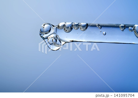 Pipette dripping serum with hyaluronic acid for skincare 141095704
