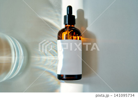 Biotech serum dropper bottle creating light refraction Biotech serum dropper bottle creating light refraction 141095734