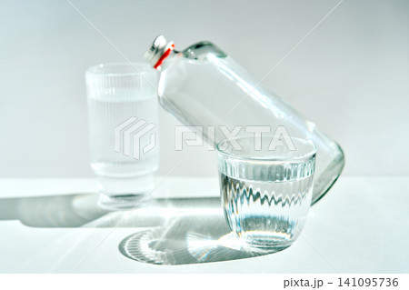 Alkaline water filling glasses, promoting healthy hydration Alkaline water filling glasses, promoting healthy hydration 141095736