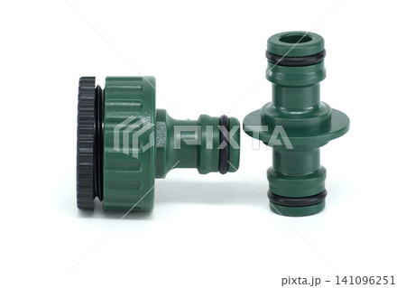 Green plastic garden hose connectors with rubber seals on a white background Green plastic garden hose connectors with rubber seals on a white background 141096251