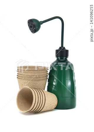 Gardening starter kit with peat pots and a green watering can with adjustable nozzle 141096255