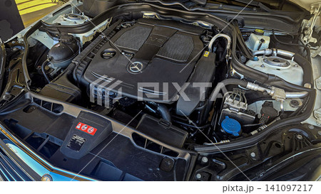 Mercedes V6 Engine Bay Under Open Hood Showing Car Motor Components and all engine mechanical Mercedes V6 Engine Bay Under Open Hood Showing Car Motor Components and all engine mechanical 141097217