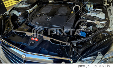 Mercedes V6 Engine Bay Under Open Hood Showing Car Motor Components and all engine mechanical Mercedes V6 Engine Bay Under Open Hood Showing Car Motor Components and all engine mechanical 141097219