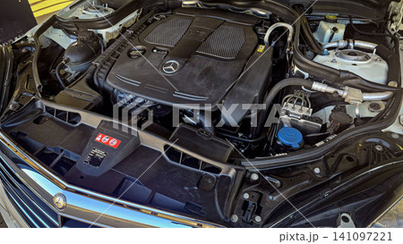 Mercedes V6 Engine Bay Under Open Hood Showing Car Motor Components and all engine mechanical Mercedes V6 Engine Bay Under Open Hood Showing Car Motor Components and all engine mechanical 141097221