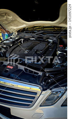 Mercedes V6 Engine Bay Under Open Hood Showing Car Motor Components and all engine mechanical Mercedes V6 Engine Bay Under Open Hood Showing Car Motor Components and all engine mechanical 141097224
