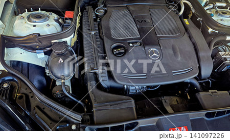 Mercedes V6 Engine Bay Under Open Hood Showing Car Motor Components and all engine mechanical Mercedes V6 Engine Bay Under Open Hood Showing Car Motor Components and all engine mechanical 141097226