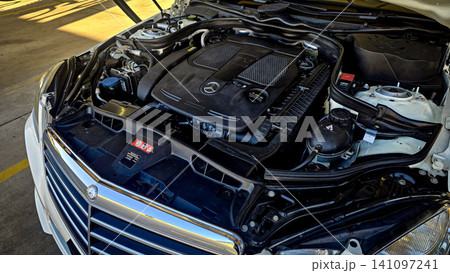 Mercedes V6 Engine Bay Under Open Hood Showing Car Motor Components and all engine mechanical Mercedes V6 Engine Bay Under Open Hood Showing Car Motor Components and all engine mechanical 141097241