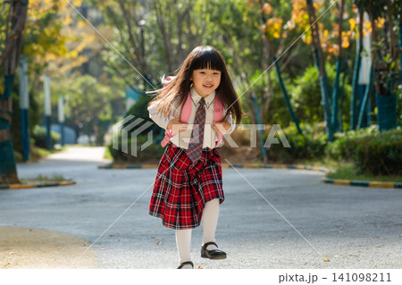 asian little girl running to school with backpack, energetic childhood and active lifestyle concept asian little girl running to school with backpack, energetic childhood and active lifestyle concept 141098211