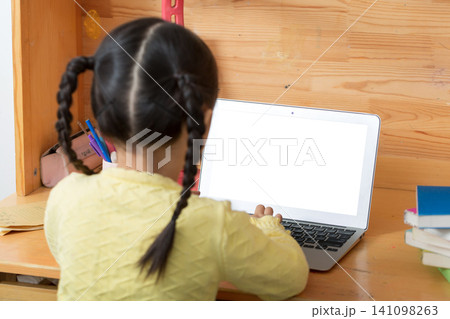 cheerful Asian girl using laptop for online class at home, distance learning and e-education concept. cheerful Asian girl using laptop for online class at home, distance learning and e-education concept. 141098263