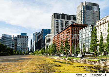 View of the Kokyo Gaien's Babasaki moat with the Marunouchi Modern office building in Chiyoda, Tokyo, Japan. Marunouchi is the core of the Tokyo central business district. View of the Kokyo Gaien's Babasaki moat with the Marunouchi Modern office building in Chiyoda, Tokyo, Japan. Marunouchi is the core of the Tokyo central business district. 141098471