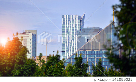 Building surrounded with green trees.  Eco-friendly building. Sustainable architecture of city reducing heat carbon dioxide modern city environment. 141099023