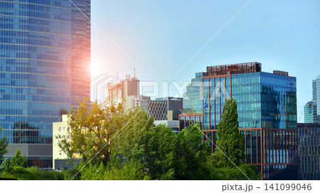 Building surrounded with green trees. Eco-friendly building. Sustainable architecture of city reducing heat carbon dioxide modern city environment. Building surrounded with green trees. Eco-friendly building. Sustainable architecture of city reducing heat carbon dioxide modern city environment. 141099046