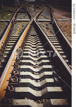 Railway junction tracks in the city with track bed. Gravel and switch at a railroad crossing. Railway junction tracks in the city with track bed. Gravel and switch at a railroad crossing. 141099170