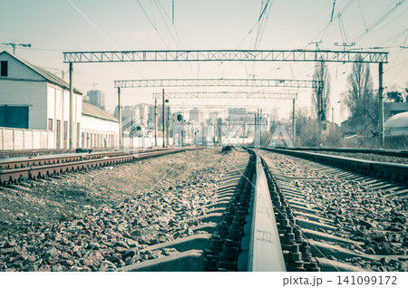 Railway tracks in the city with track bed. Gravel and switch at a railroad crossing. Railway tracks in the city with track bed. Gravel and switch at a railroad crossing. 141099172