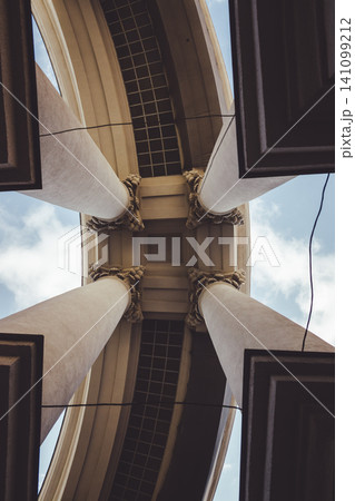 Portico of the building of the Ministry of Foreign Affairs. View from below on the columns of the portico of the Ministry of Foreign. In the middle of four columns Portico of the building of the Ministry of Foreign Affairs. View from below on the columns of the portico of the Ministry of Foreign. In the middle of four columns 141099212
