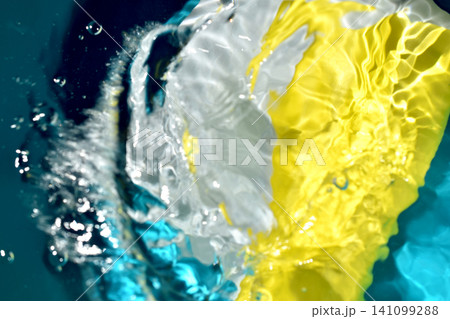 A textured design created by depicting the surface of water with vibrant yellow and blue accents. A textured design created by depicting the surface of water with vibrant yellow and blue accents. 141099288