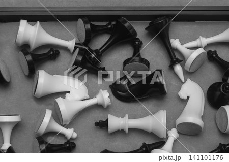 Top view of fallen black and white chess pieces messy in a box, bankruptcy and game over concept. Top view of fallen black and white chess pieces messy in a box, bankruptcy and game over concept. 141101176