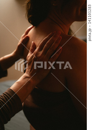 Back massage with hands close-up Back massage with hands close-up 141101283